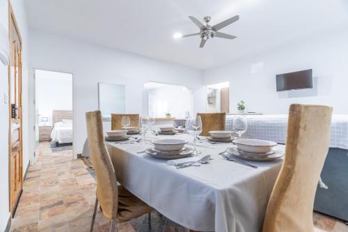 a dining room with a white table with chairs at Casa rural Acueducto in Almería