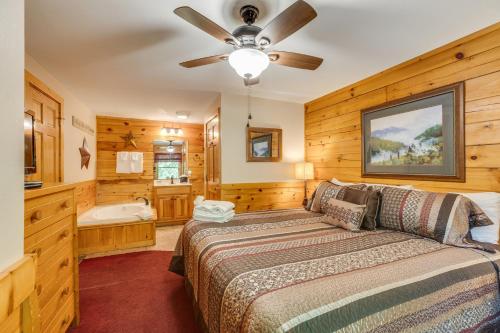 a bedroom with a bed and a ceiling fan at Hugs N Kisses Pool Table Hot Tub Pool Table Community Pool Close to Downtown Gatlinburg in Gatlinburg