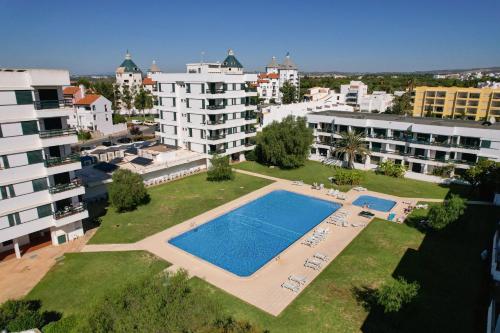 an aerial view of a swimming pool in a city at Centralgarve - Elegant and Cosy Studio in the Heart of Vilamoura - Aldeia do Mar T0 in Vilamoura