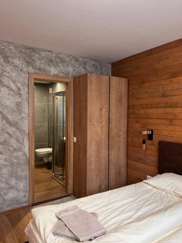 a bedroom with a bed and a bathroom with a toilet at Alpine luxury two bed-two bathrooms apartment B25 in Borovets