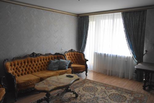 a living room with a couch and a table at Provence apartment in Šiauliai
