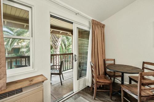 a dining room with a table and chairs and a balcony at El Pueblo Inn in Sonoma