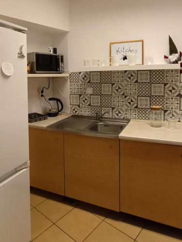 a kitchen with a sink and a refrigerator at Prywatny pokój dla dwóch osób Pokój 2 in Warsaw