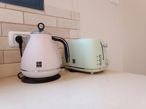 a white appliance sitting on a counter next to a toaster at אתיטיוד בערבה attitude at the arava in H̱aẕeva