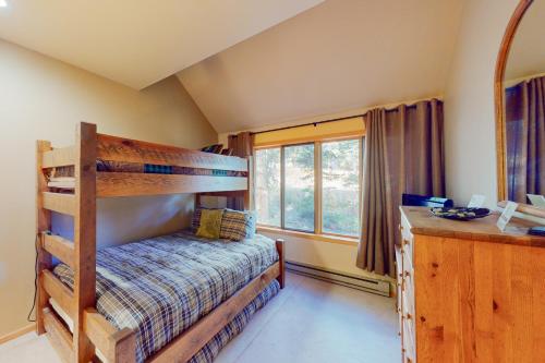 a bedroom with a bunk bed and a window at Cool Ridge Town Home at Summerwood in Keystone