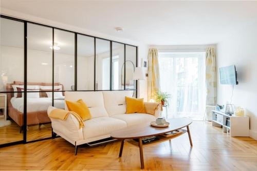 a living room with a white couch and a bed at Luxury City Centre Apartment in Dublin