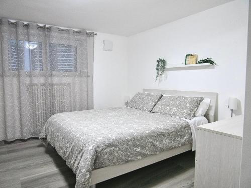 een witte slaapkamer met een bed en een raam bij THE BAC HOUSE - Maestrale in Fano