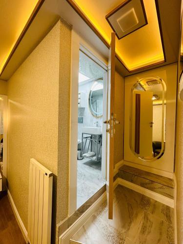 a hallway with a bathroom with a mirror at TAKSİM HAVANA HOTEL SUİTES in Istanbul