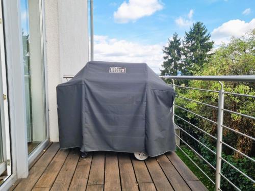 a covered table on a balcony on a deck at Mountains and Lakes - Villa Gaumberg in Linz