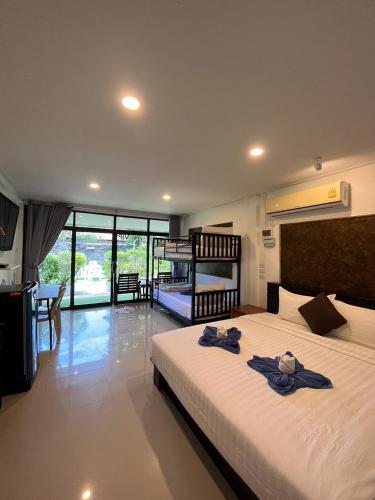 a bedroom with a bed with two towels on it at Klongdao Sunset Villa in Ko Lanta