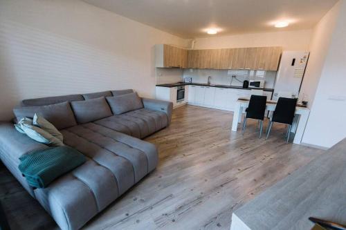 a living room with a couch and a kitchen at Miracle in Bratislava