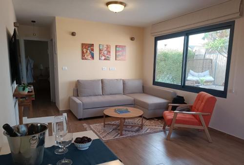 a living room with a couch and a table at אתיטיוד בערבה attitude at the arava in H̱aẕeva