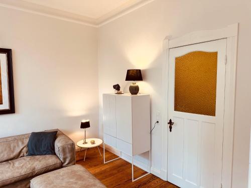 a living room with a couch and a door at Villa am Strand in Eckernförde
