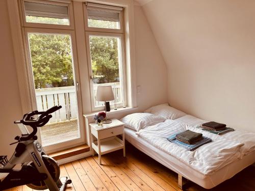 a small bedroom with a bed and a window at Villa am Strand in Eckernförde