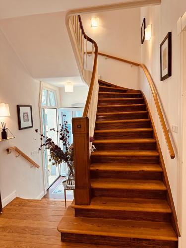 a staircase in a home with wooden floors at Villa am Strand in Eckernförde