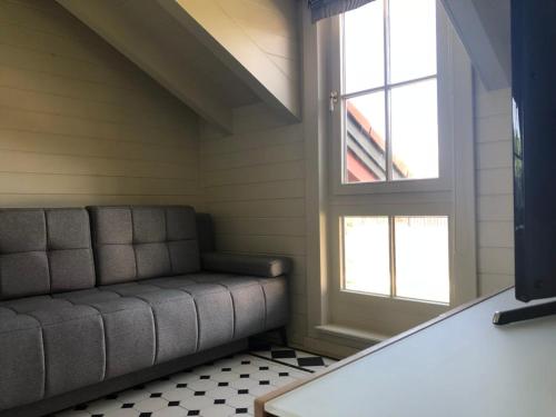 a living room with a couch and a window at Rotes Haus in Füssen Apartment Klassik in Füssen