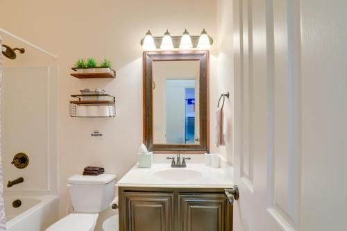 a bathroom with a sink and a toilet and a mirror at Covered Patio and Large yard Mansfield Home in Mansfield