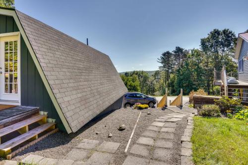 a building with a car parked next to a driveway at Charming Claverack Retreat with Serene Deck! in Claverack