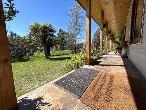 a welcome mat on the sidewalk of a house at Casa Foresta - BBQ Cocina Piscina Mascota Wifi in Melipilla