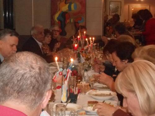 a group of people sitting at a dinner table at Hotel Pegasos in Nikiana