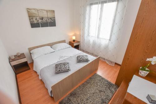 a bedroom with a bed with two pillows on it at Apartments TIM in Sveti Petar