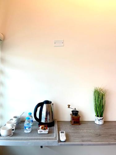 a tea kettle and cups on a shelf at RoadHouse - Petra in Wadi Musa
