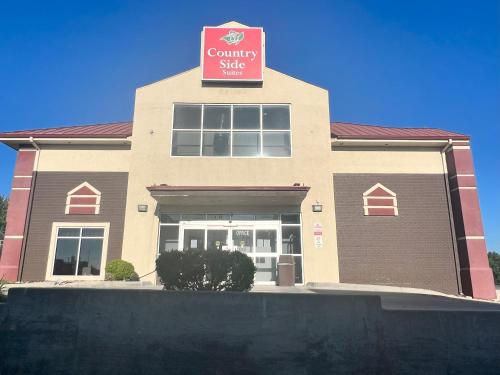 a building with a sign that reads community shop at Countryside Suites Kansas City Independence I-70 East Sports Complex Hotel in Independence