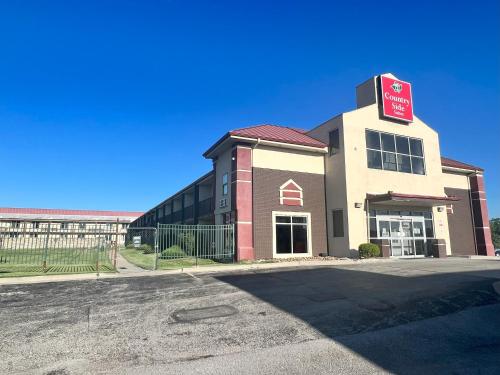 a building with a sign on the top of it at Countryside Suites Kansas City Independence I-70 East Sports Complex Hotel in Independence