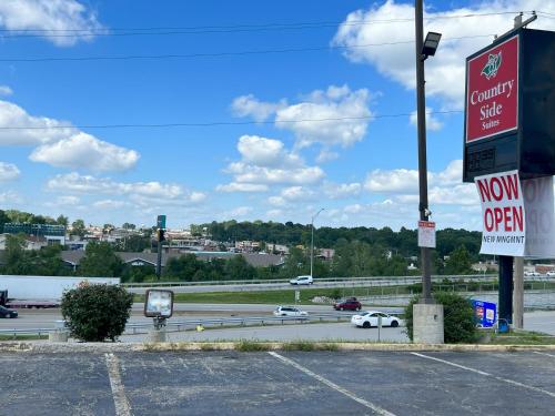 a parking lot with a sign for a car dealership at Countryside Suites Kansas City Independence I-70 East Sports Complex Hotel in Independence