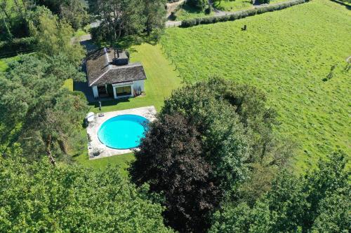 an overhead view of a house with a swimming pool in a field at Sy - Les Aywisses in Ferrières