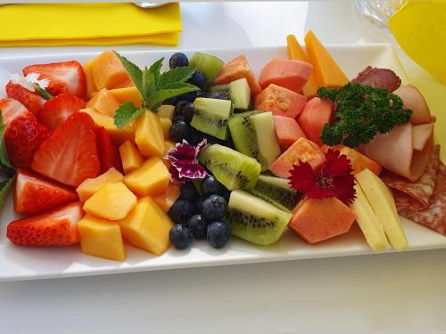 a plate of fruits and vegetables on a table at Fleur du Soleil Luxury Guesthouse in Franschhoek