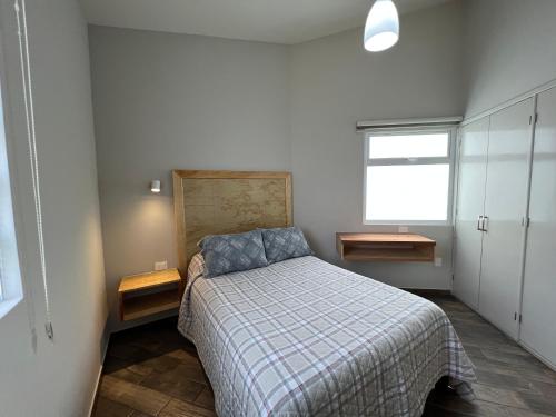 a bedroom with a bed with a plaid blanket at Privada 400 in Pachuca de Soto