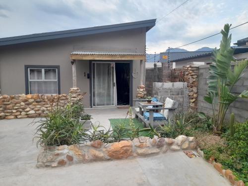 a home with a patio and a house at Angel 8 AirBnB Apartment 1 in Robertson