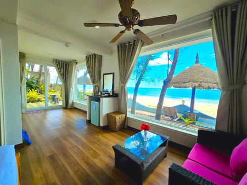 a living room with a view of the ocean at Casa Beach Resort in Phan Thiet