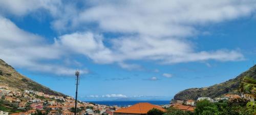 a view of a town between two mountains at Studio em Machico in Machico