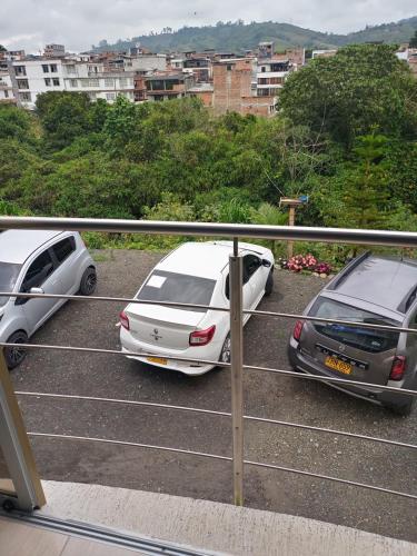 a couple of cars parked in a parking lot at Apartamento portal del prado in Santa Rosa de Cabal