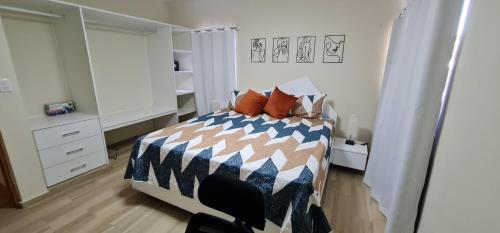 a bedroom with a bed with pillows on it at Apartament central frente al mar in San Felipe de Puerto Plata