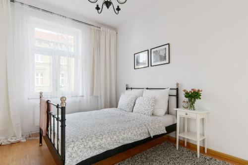 Ένα ή περισσότερα κρεβάτια σε δωμάτιο στο Apartament Nowe Miasto - przy Deptaku Chrobrego