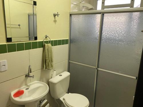 a bathroom with a toilet and a sink and a shower at RCM Vilas - Studio n17 in Joinville
