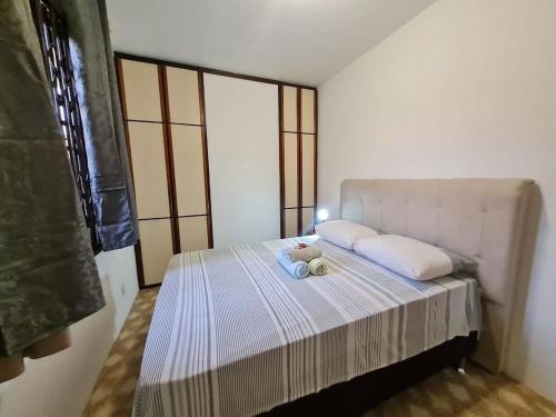 um quarto com uma cama com um bicho de peluche em RCM Vilas - YELLOW HOUSE em Joinville