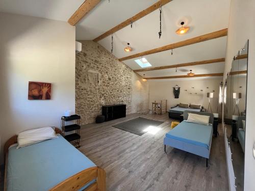 sypialnia z 2 łóżkami i salon w obiekcie Domaine Mas Côté Cour w mieście Maubec