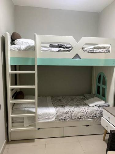 two bunk beds in a room with a bed at Apartamento Miraflores in Lima