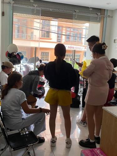 a group of people standing around in a room at Bơ House hotel in Da Lat