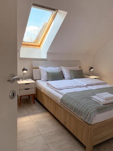 a bedroom with a large bed with a skylight at The View 22 in Cerklje na Gorenjskem