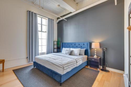 a bedroom with a blue bed with a blue headboard at Downtown Los Angeles Condo with Shared Rooftop Pool! in Los Angeles
