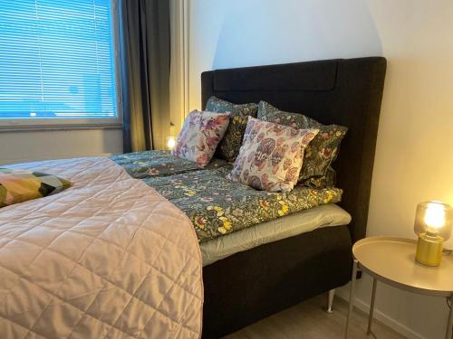 a bedroom with a large bed with pillows on it at Funky City Apartment in Rovaniemi