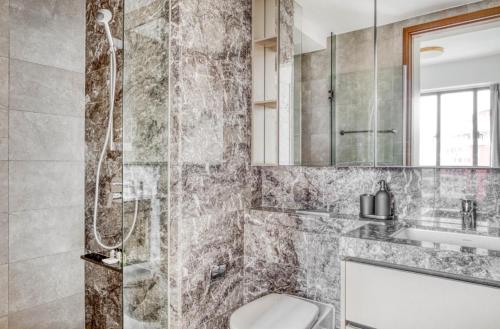 a bathroom with a shower and a toilet at Beautiful 2Bedroom apartment in Singapore! in Singapore