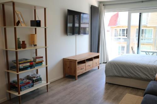 a bedroom with a bed and a book shelf at Chez Pascal - Nieuport in Nieuwpoort