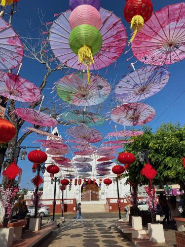 a bunch of umbrellas hanging over a street at Uverito Sand Dollar B&B in Las Tablas
