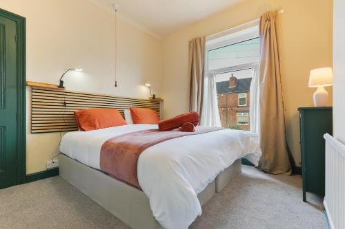 a bedroom with a large bed and a window at Home from Home 4 Bed - Ideal for Workers & Great for Groups, FREE Parking, Spacious, Pet Friendly Netflix in Kimberworth